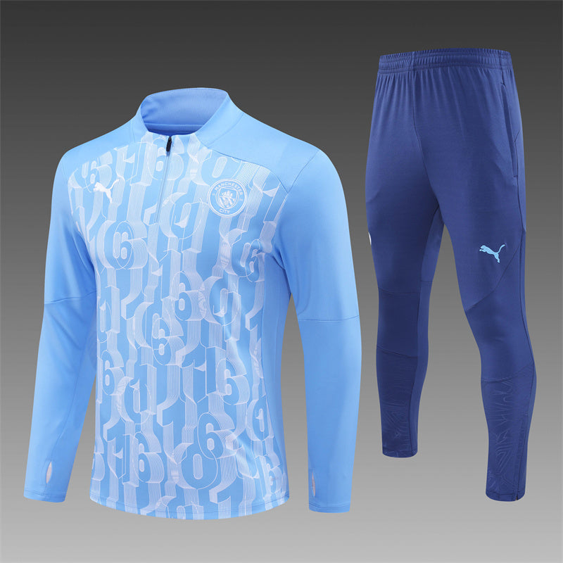 Manchester City 2024/2025 blue tracksuit laid flat with full zip jacket and pants.