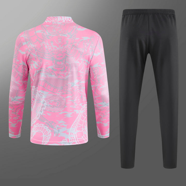 Real Madrid tracksuit in pink with dragon design, showcasing the sleek collar and cuffs