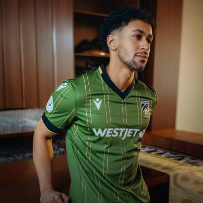 Close-up of the Cavalry FC jersey’s gold-trimmed collar and cuffs.