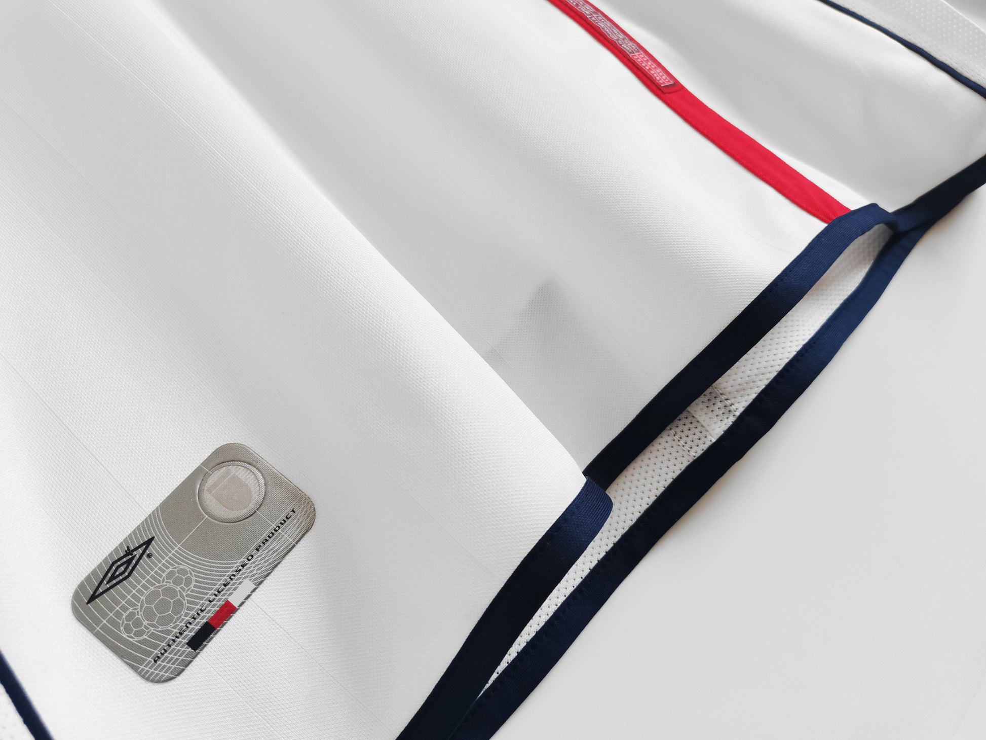 England 2002 Home Jersey in full view, featuring the bold red and navy accents along with the Umbro branding