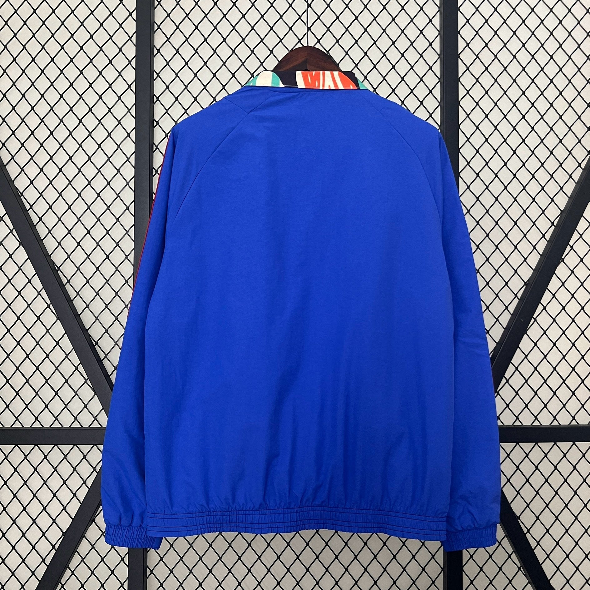 Arsenal 24/25 Ian Wright jacket hanging on rack, back side 