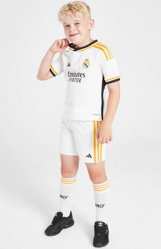 Boy wearing Real Madrid 2023 kids home soccer kit