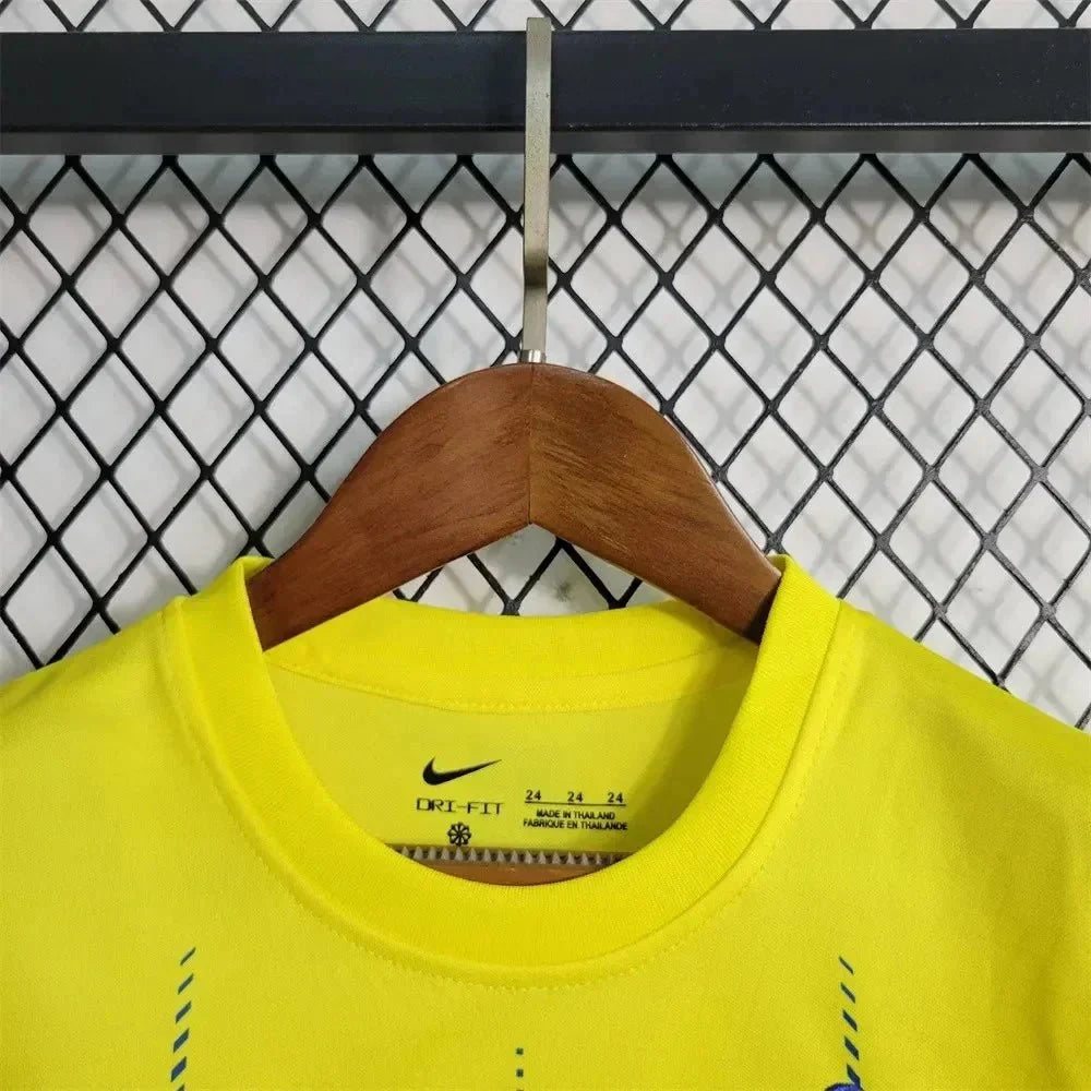 Child in Al-Nassr 23/24 home jersey and shorts