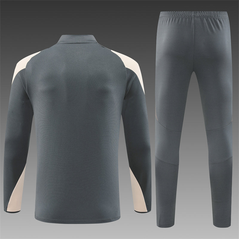 Close-up of the Real Madrid grey tracksuit detailing, including the club crest