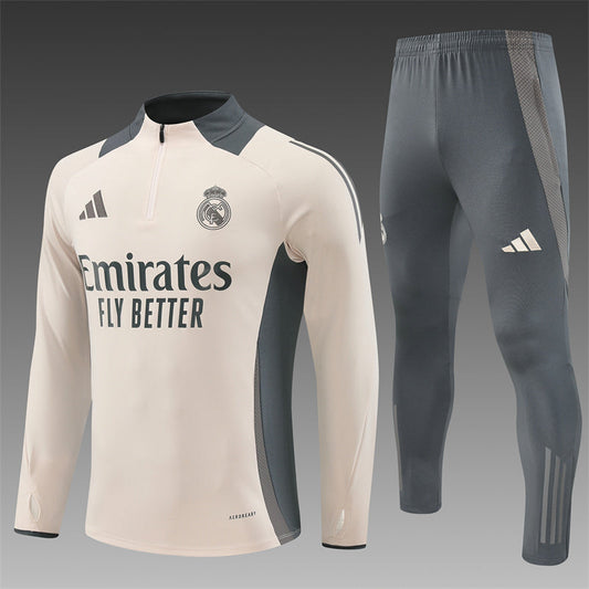 Real Madrid cream tracksuit front view, featuring the iconic club logo and clean design.