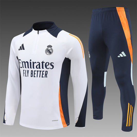 Real Madrid white and orange tracksuit for kids, showing the club logo on the jacket and sleek design